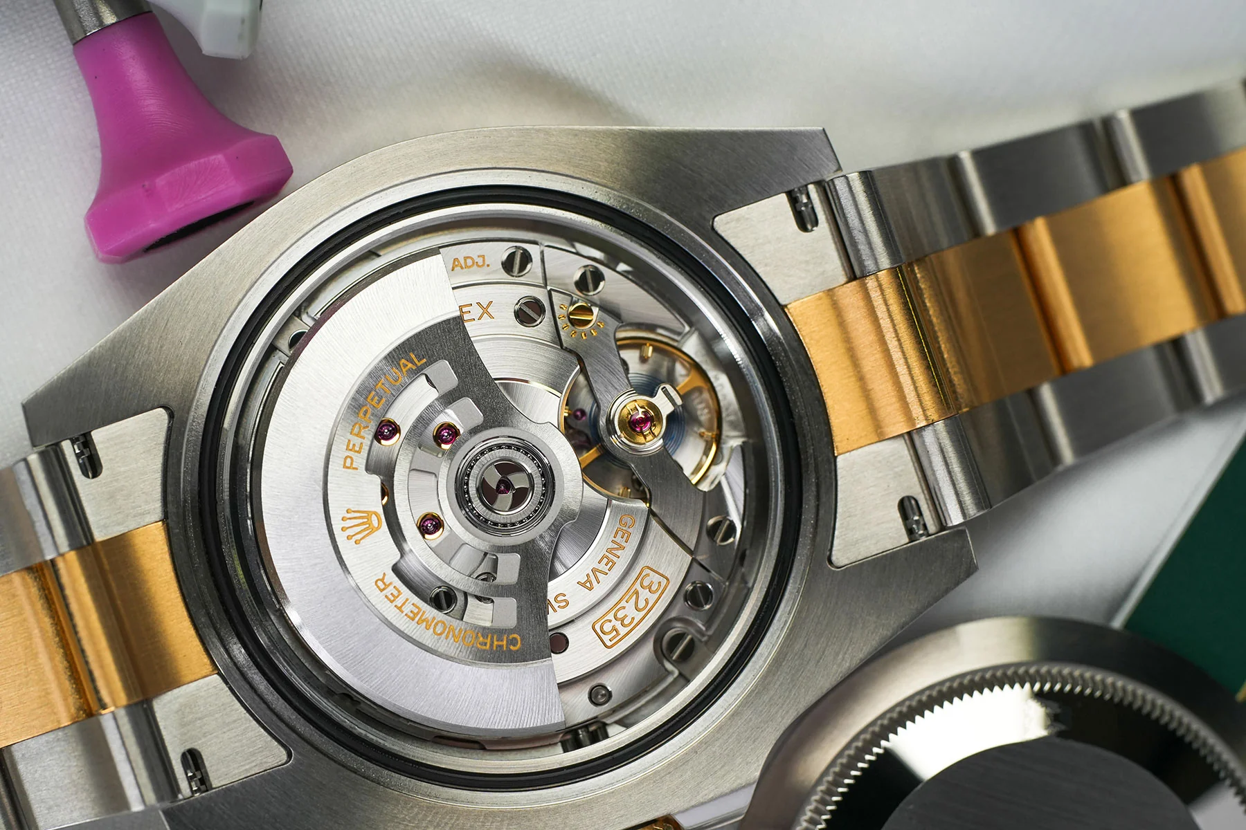 Watch repair inspection notes alongside a timepiece and specialist tools
